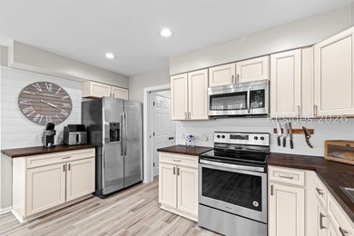 This beautifully updated residence offers laminate wood flooring - photo 18