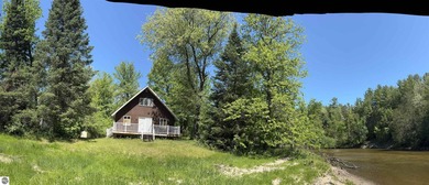 Nestled along the beautiful Rifle River, this charming - photo 1