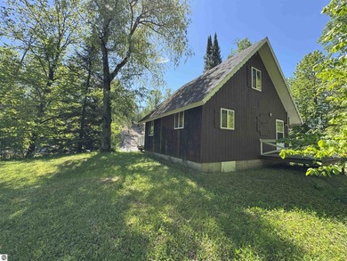 Nestled along the beautiful Rifle River, this charming - photo 5