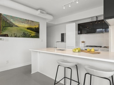 Perched on the coveted NW comer of the sub-penthouse level, this - photo 8