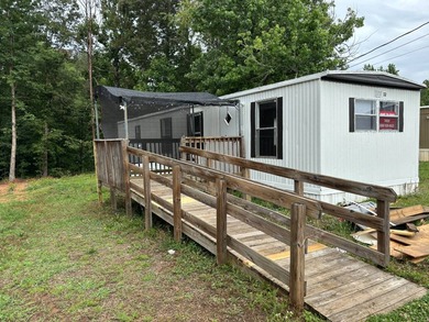 This 1980 2-bedroom 1-bathroom mobile home offers comfort - photo 1