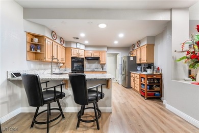 A rare single-story townhome in the gated Promenade at the