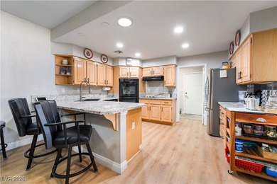 A rare single-story townhome in the gated Promenade at the