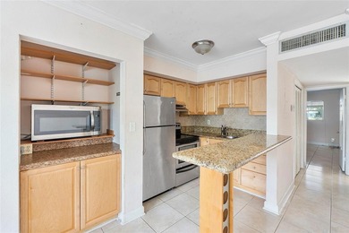 Discover a chic 2-bedroom, 1-bath corner unit condo with - photo 2