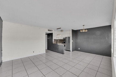 Discover a chic 2-bedroom, 1-bath corner unit condo with - photo 3