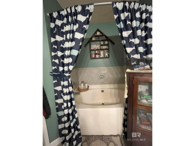 Nestled on the outskirts of Fairhope, this appealing