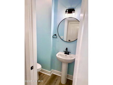 Experience elevated coastal living in this impeccably crafted