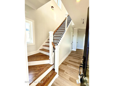 Experience elevated coastal living in this impeccably crafted