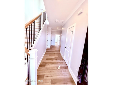 Experience elevated coastal living in this impeccably crafted