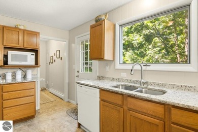 Nestled among mature hardwoods on a private wooded setting, this - photo 8
