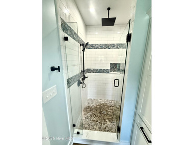 Experience elevated coastal living in this impeccably crafted