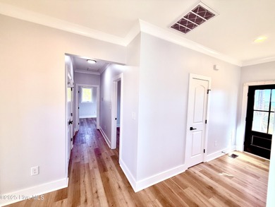 Experience elevated coastal living in this impeccably crafted