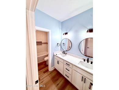 Experience elevated coastal living in this impeccably crafted