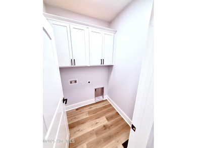 Experience elevated coastal living in this impeccably crafted