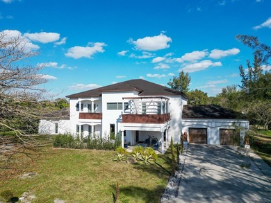 Situated on an expansive 2.23-acre estate, this exceptional - photo 1