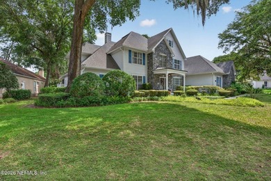 Situated on an oversized corner lot framed by mature oaks, this - photo 3