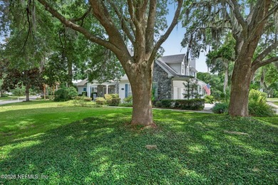 Situated on an oversized corner lot framed by mature oaks, this - photo 4
