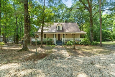 Hidden beneath towering hardwoods on a private wooded setting - photo 1