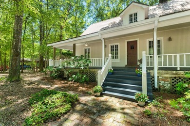 Hidden beneath towering hardwoods on a private wooded setting - photo 4