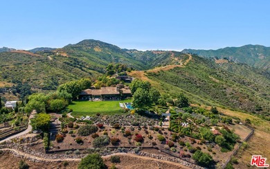Tucked away behind gates atop the Malibu hills, this enchanting - photo 2