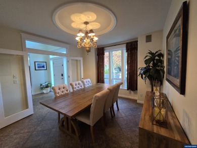 Exquisite home features vaulted ceilings & arched windows