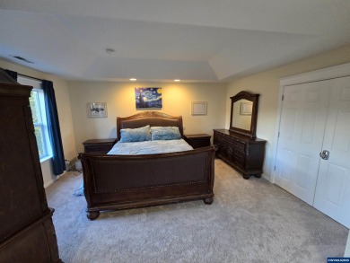 Exquisite home features vaulted ceilings & arched windows