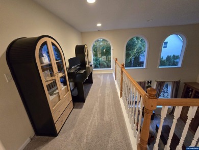 Exquisite home features vaulted ceilings & arched windows