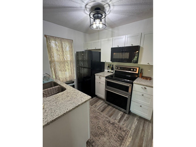 Highly sought after ground floor corner end unit overlooking the - photo 6