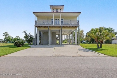 Tucked inside the highly sought-after Pass Christian Isles, this - photo 1