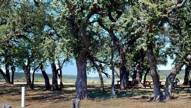 Level two acre lot with potential for a lake view. Lot ownership - photo 12