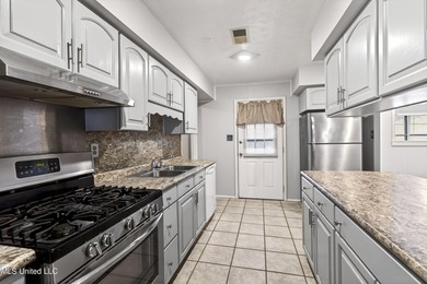 This well-maintained 3-bedroom brick home in Long Beach offers a - photo 14