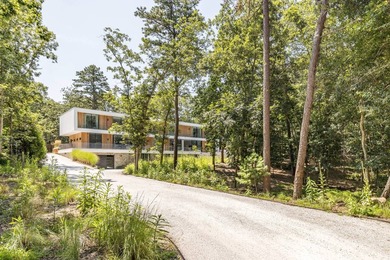 Set amidst lush greenery in one of the Hamptons' most serene - photo 1