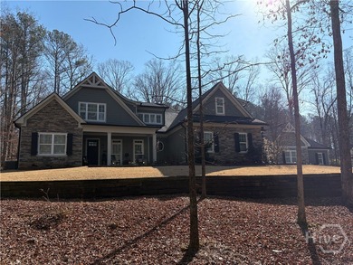 Tucked away on a serene two-acre wooded lot, this stunning