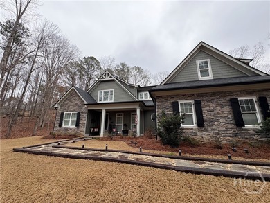 Tucked away on a serene two-acre wooded lot, this stunning