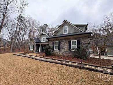 Tucked away on a serene two-acre wooded lot, this stunning