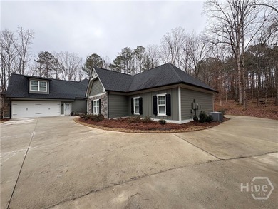 Tucked away on a serene two-acre wooded lot, this stunning