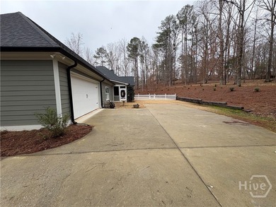 Tucked away on a serene two-acre wooded lot, this stunning