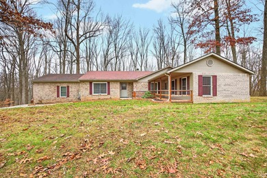 This brick ranch home sits in a peaceful wooded area at the end