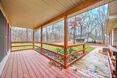 This brick ranch home sits in a peaceful wooded area at the end