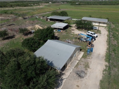 Discover this versatile 5-acre property featuring multiple