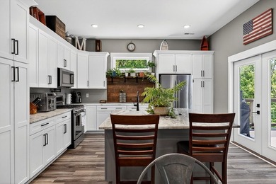 This waterfront lake home showcases an open floorplan and - photo 16
