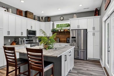 This waterfront lake home showcases an open floorplan and - photo 17