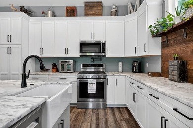 This waterfront lake home showcases an open floorplan and - photo 18