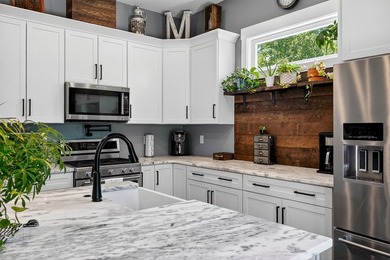 This waterfront lake home showcases an open floorplan and - photo 19