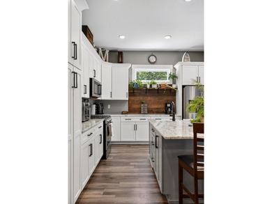 This waterfront lake home showcases an open floorplan and - photo 20