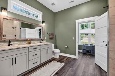 This waterfront lake home showcases an open floorplan and - photo 32