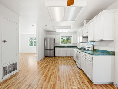 This beautifully updated 4-bedroom, 2-bathroom home with a 2-car - photo 7