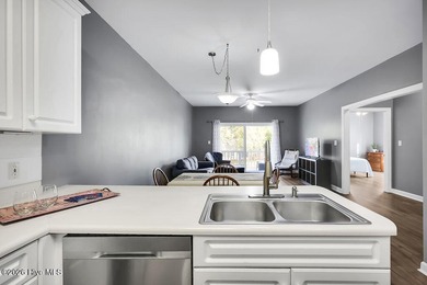 This desirable end-unit condominium offers a light-filled layout