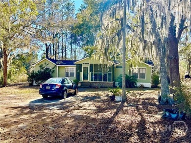 Sitting on a full acre with beautiful mature oaks, this home - photo 1