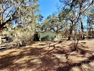 Sitting on a full acre with beautiful mature oaks, this home - photo 6